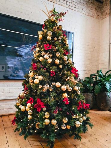 Classic Christmas spiral tree at private function at The Hotel Britomart featuring lights & skirt.