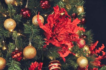 Traditional red and gold bauble and flower tree - closeup.