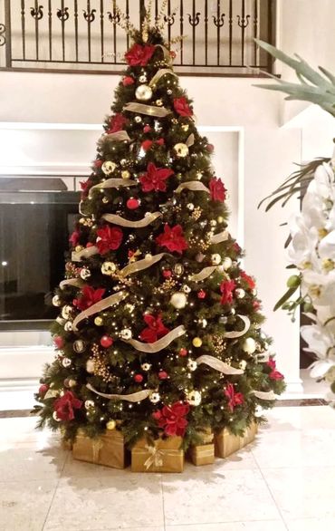 Luxurious 11 foot tall Christmas tree with presents.