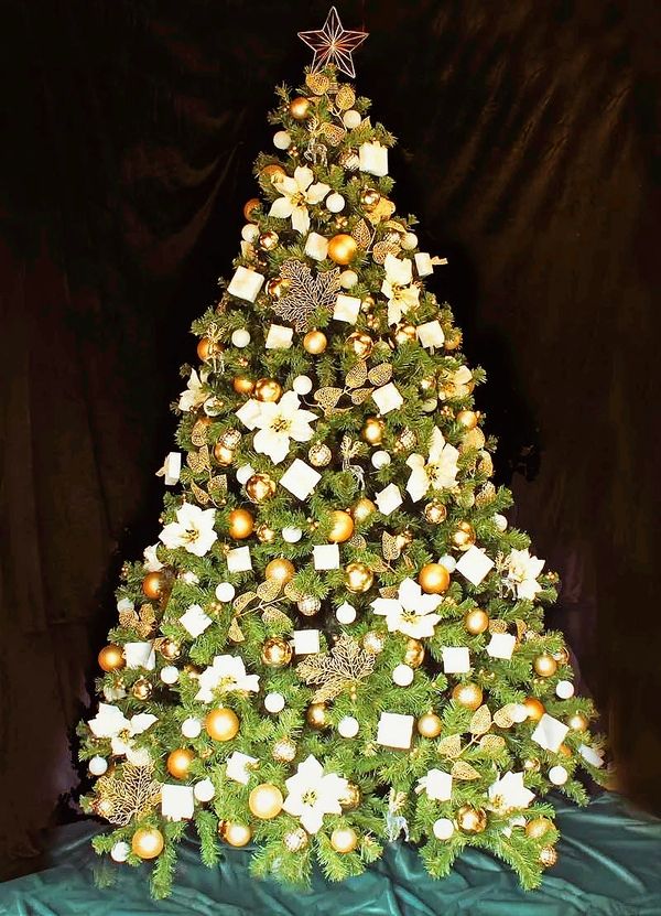 Fully decorated white and gold mini present box Christmas tree with wire star topper.