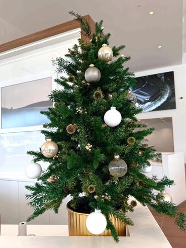 Table-top Christmas tree in metal pot featuring glass baubles, berries and preserved leaves + seeds.