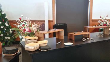 Fun colourful candy themed Christmas party centrepieces on party desert station.