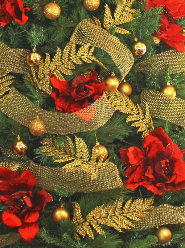 Closeup of our red and gold decorations on red rose Christmas tree for hire.