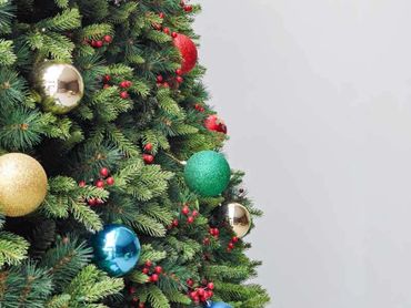 Closeup of decorations on 6m Christmas tree featuring snowflakes, berries, and colourful baubles.