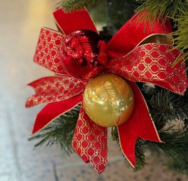 Clousep of handmade "bauble bow" with patterned and velvet wire edged ribbon in red and gold.
