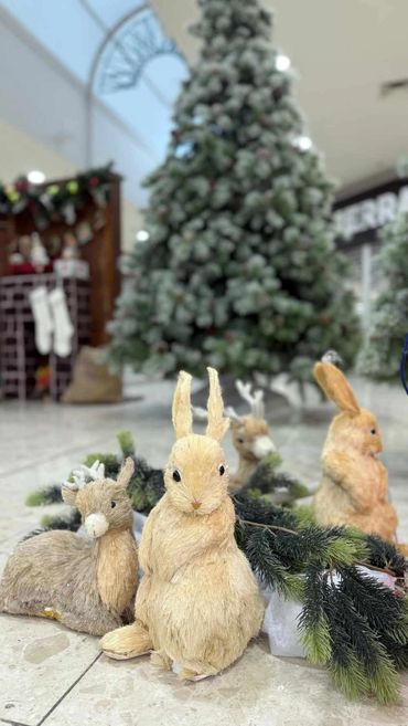 Woodland bunnies in front of Santa's cozy house grotto at Pakuranga Plaza shopping mall for 2025.