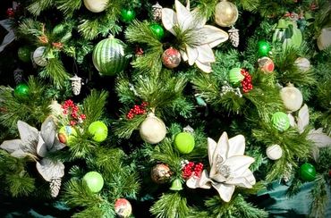 Closeup of decorations on native NZ birds green and gold with grey and pearl colours Christmas tree.