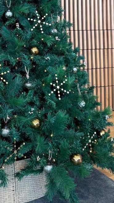 Closeup all-natural metal and glass ornaments with handmade snowflakes for car showroom Xmas tree.