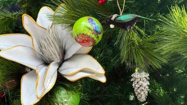 Closeup of Christmas tree decorations featuring foam magnolia flower, pukeko bauble and tai bird.