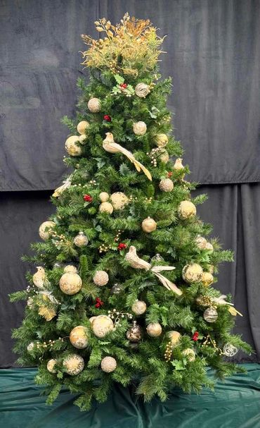 Luxury large dove Christmas tree with vanilla white and gold bauble clusters and holly leaves.