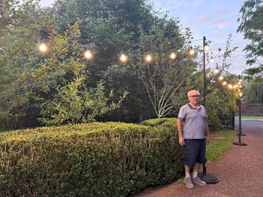 David standing next to our heavy duty tall festoon [oles in black.