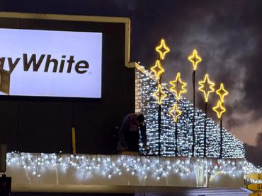 Bright commercial fairy lights on building with Matariki star light formation - custom made.