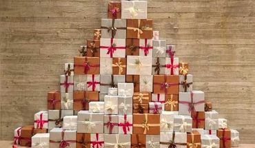 Giant extravagant present stack display with luxury wrapping paper and bows.