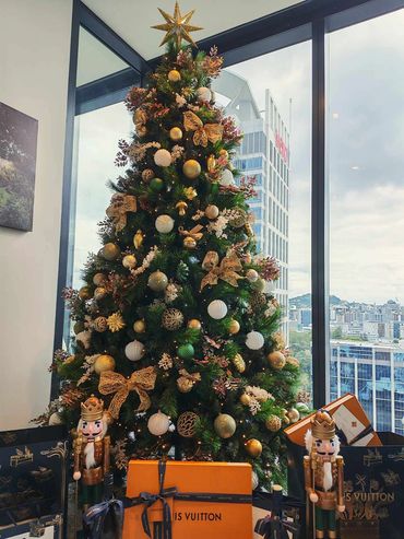 Sage & gold decorations on Christmas tree with snowy white detail and fancy presents + nutcrackers.