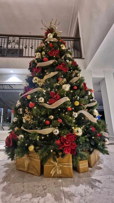 11 foot tall luxury red & gold Christmas tree with warm white lights.