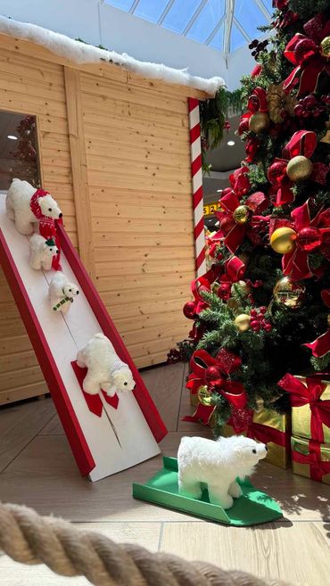 Traditional look Santa grotto featuring red and gold thumbing with fun details at Coast Plaza 2025.