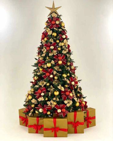 Professional studio photo of big red bows and gold baubles Christmas tree with presents.