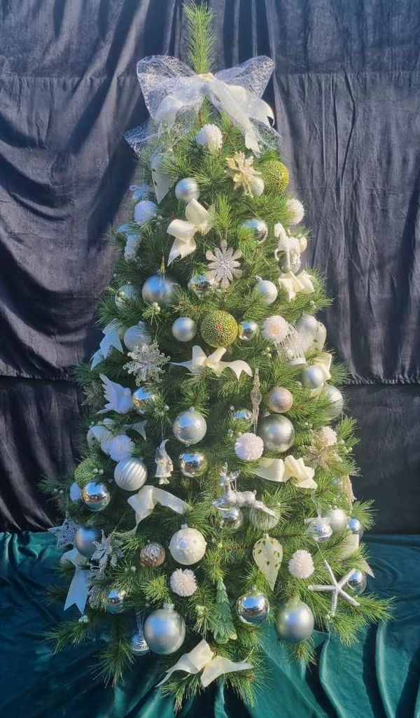 Luxury white and green Christmas decorations on realistic 6 foot artificial pine tree.