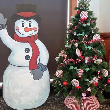 Small 6 ft tall candy and lollipop Christmas tree with waving cutout wooden snowman (hand painted).