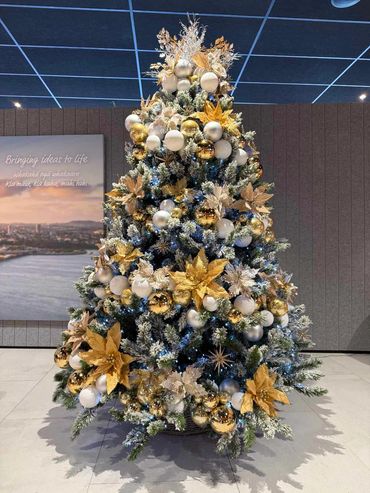 Champaign gold and ivory bauble spiral tree on Snow White realistic artificial pine tree at office.