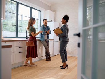 A real estate agent showing a house to potential buyers