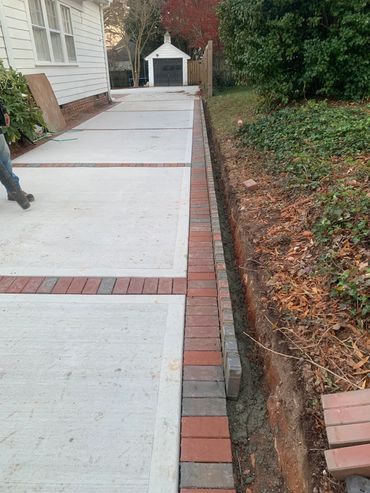Brick border on concrete driveway in Raleigh North Carolina.