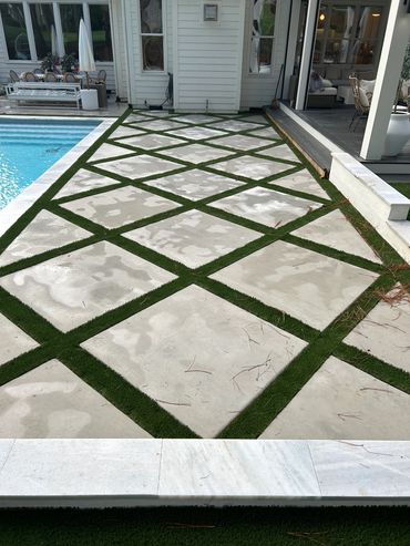 Concrete pool deck with artificial turf in wake forest North Carolina.