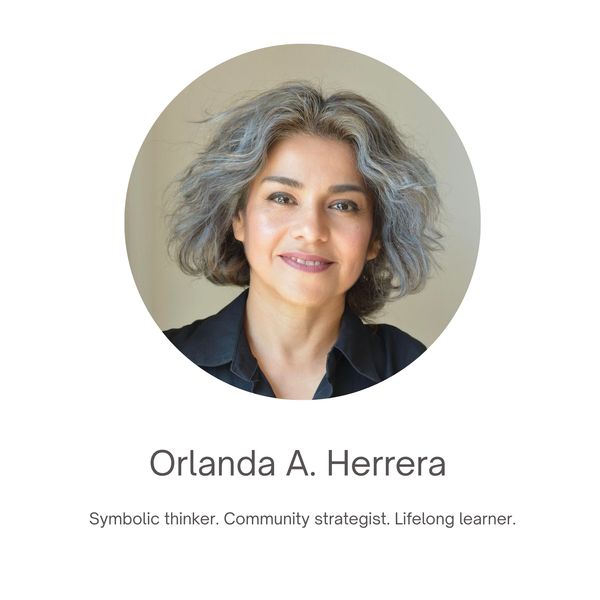 Portrait of Orlanda A. Herrera with a warm smile and gray hair.