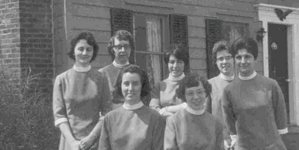 Nuns in 1969 sitting outside of house with black shutters