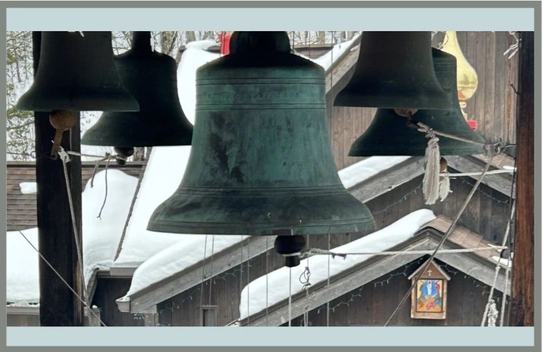 Bells in tower. church with snow on the roof.