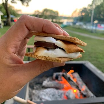 s'mores cooked over a campfire by the lake