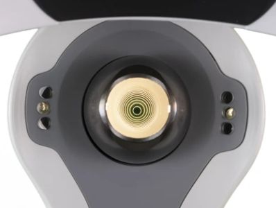 Close-up of a corneal topographer with concentric circles visible inside.