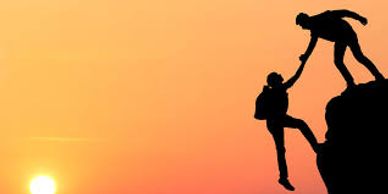 A hiker helping another hiker up a cliff. Veterans Moving will help you reach your goals.