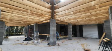 Construction site with wood beams and ladders.
