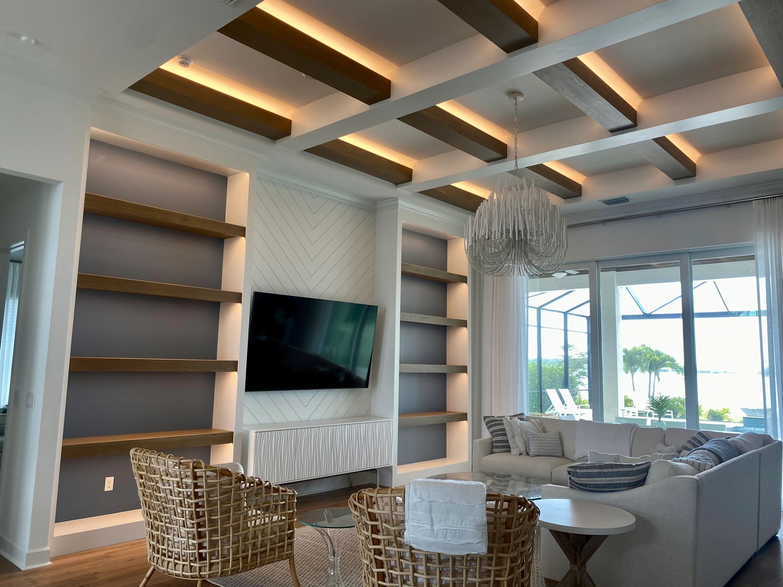 Custom residential lighting installation with illuminated ceiling details and built-in shelf accent lighting by MAZ Electric