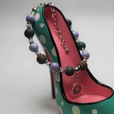 Beaded anklet with dangling charm.