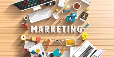 Creative marketing workspace with various tools and gadgets arranged neatly.