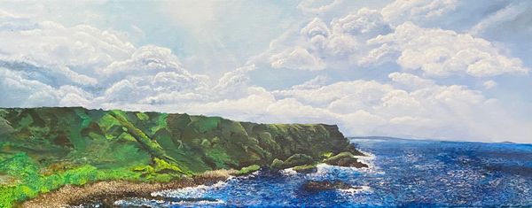 A scenic coastal cliff with vibrant greenery under a bright sky.