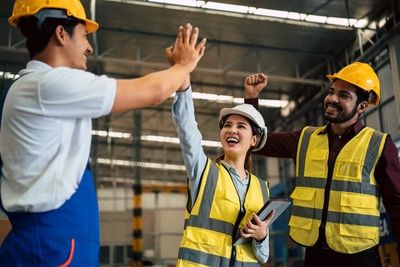 Warehouse Workers High Fiving
