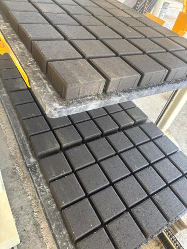 Stacks of dark and light gray square tiles.