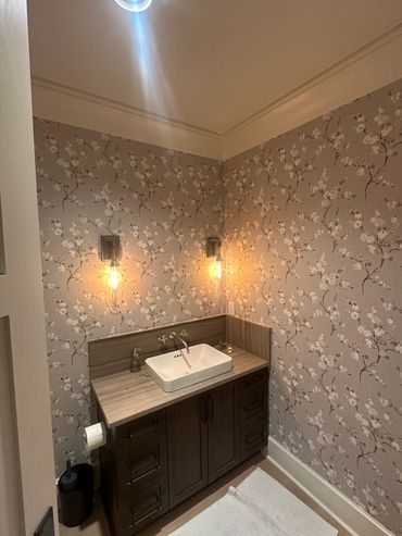 Wallpaper install in a water closet.