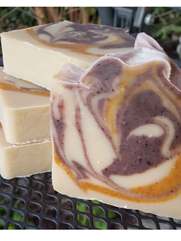 Handmade swirled soap bars with creamy and purple hues.