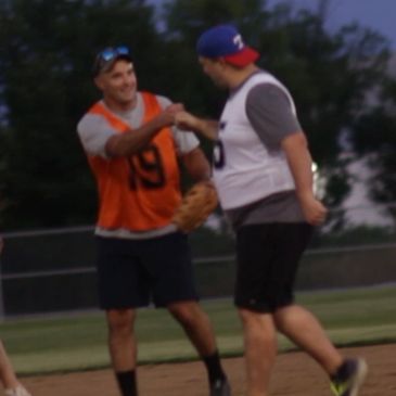 Two baseball players reacting on the field, congratulating a good play made during 5-Pitch Plucky®.