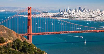 Golden Gate Bridge with San Francisco skyline in the background on a clear day.