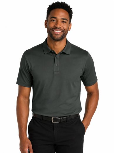 Smiling man wearing a dark green polo shirt and black pants.