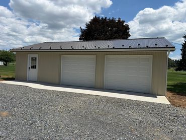 Pole barn style 2 car garage with fitness center.