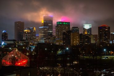 Clouds and building lighting intersect in an explosion of color over the Minneapolis MN skyline