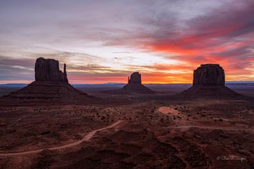 Monument valley before sunrise. Brilliant red and orange colors and mitten and merrick buttes