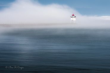 Fog at Two Harbors Minnesota lighthouse on the lake superior north shore, MN. blues reds whites
