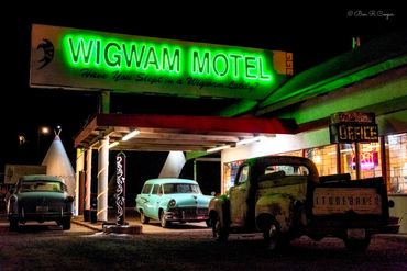 Historic Wigwam Hotel at night  (Wigwam Village #6) in Holbrook Arizona. Old cars and teepees